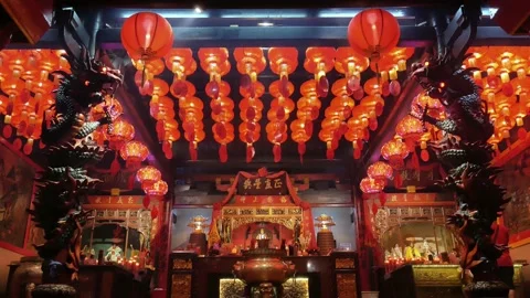 A decorated Buddhist temple with red lanterns on ceiling Stock Footage 148804213