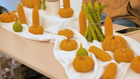 Decorated candles in vegetable shape, pumpkin, corn and asparagus Stock Footage 299811299