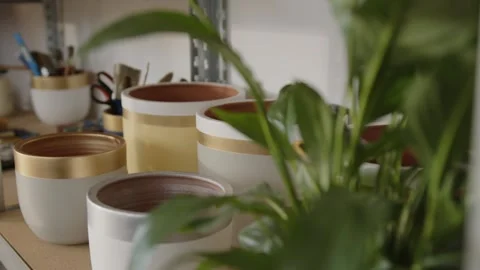 Decorated ceramic pots standing on a shelf in a pottery workshop Stock Footage 321314146