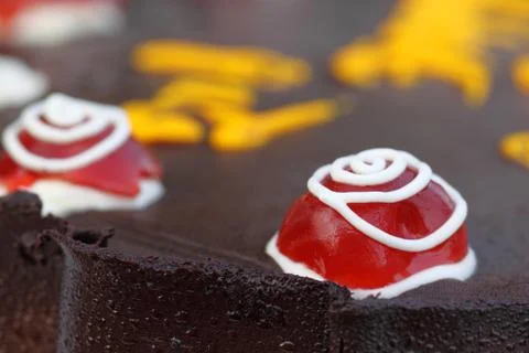 Decorated cherry on a party cake Stock Photos