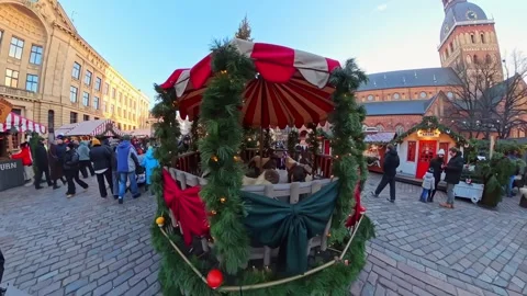 Decorated Christmas carousel with pine garlands and red-white canopy at Riga Stock Footage 327332373
