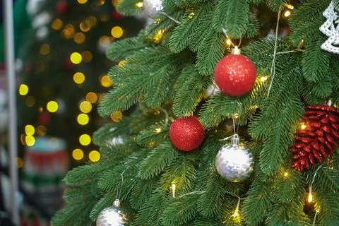 Decorated Christmas tree close-up. Red balls and illumination of garlands with Stock Photos