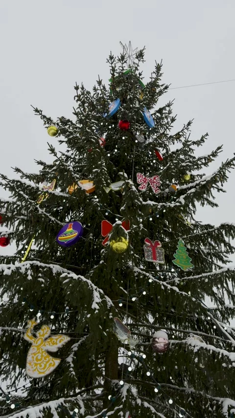 Decorated Christmas Tree Covered in Snow on a Winter Day Stock Footage 301405443