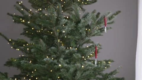 Decorated Christmas tree with crystal ornaments and moving white curtain, 4K Stock Footage 324258196