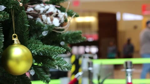 Decorated Christmas Tree in Foreground of Holiday Travelers Stock Footage 44311906