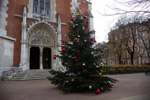 Decorated Christmas tree in front of a red Church Stock Photos