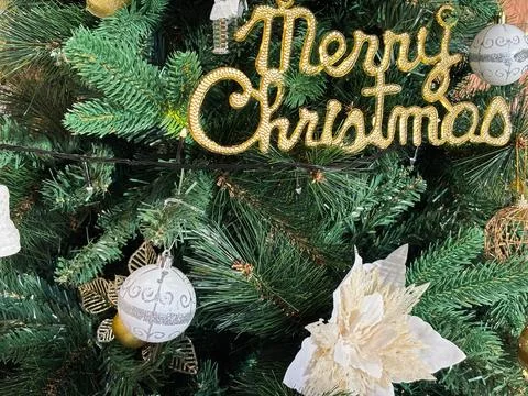 Decorated Christmas tree, gold script spelling out Merry Christmas 写真素材