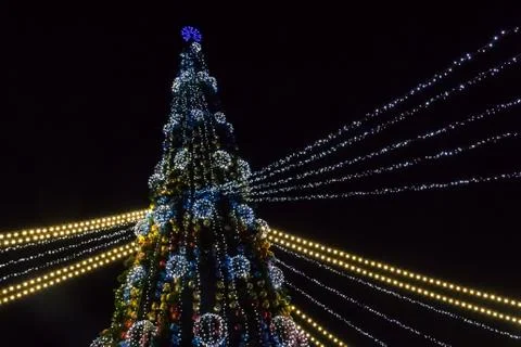 Decorated Christmas tree with multi-colored lights at night Stock Photos