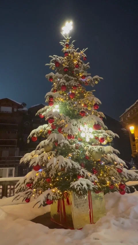 Decorated Christmas tree in a ski resort under snow Stock Footage 337195123
