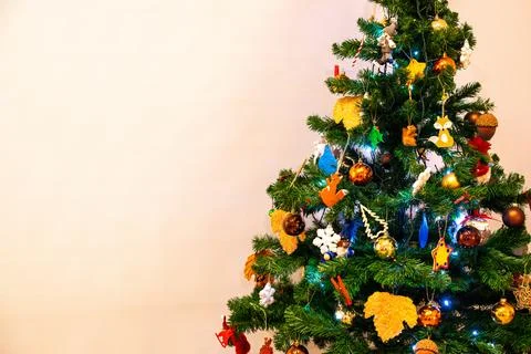 A decorated Christmas tree stands in the corner of a room. Stock Photos