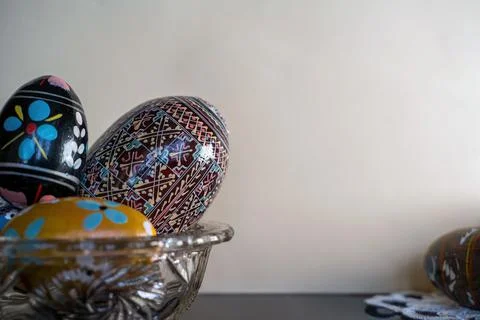 Decorated colored or painted easter eggs kept on a bowl against white backgro Stock Photos