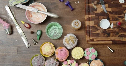 Decorated cupcakes on a table Stock Footage 117025974