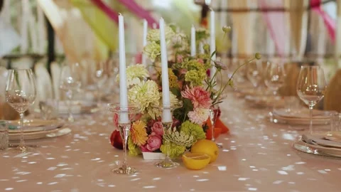 Decorated dining table with floral centerpiece and elegant candles, wedding Stock Footage 324677510