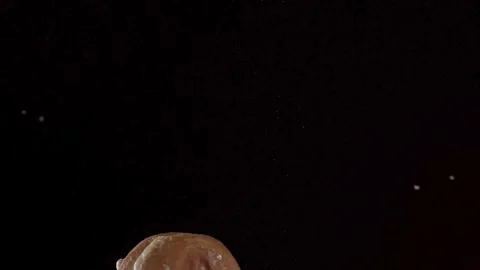 A decorated donut falls through the air in slow motion. Stock Footage 326626529