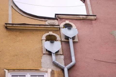 Decorated double drainpipe of two roofs on the wall of a building. Gdansk, Ol Stock Photos