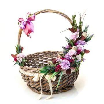 Decorated Easter basket with high handle. Decor of quail eggs and various flo Stock Photos