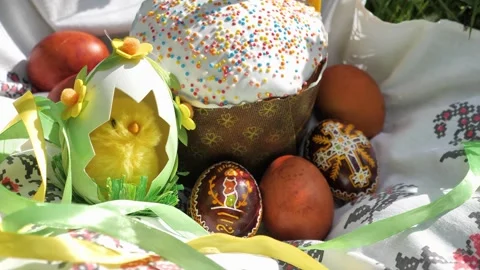 Decorated Easter Cake with Eggs, chick and candle on ethno towel among grass Stock Footage 274842934