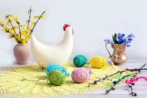 Decorated Easter eggs against the background of a chicken figure and bouquets Stock Photos