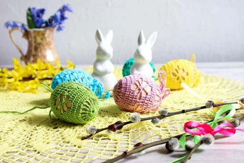 Decorated Easter eggs against the background of figurines of hares and a bo.. Stock Photos