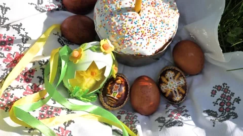 Decorated Easter Eggs and Cake with burning candle on the nature environment Stock Footage 274842944