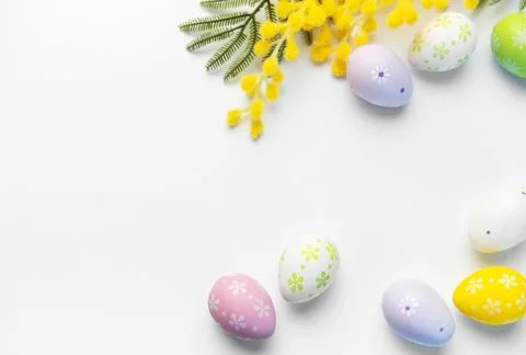 Decorated easter eggs and mimosa flowers on white background 스톡 사진
