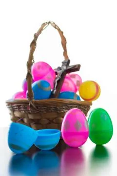 Decorated easter eggs are on a table and in a basket. Stock Photos