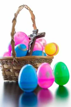 Decorated easter eggs are on a table and in a basket. Stock Photos