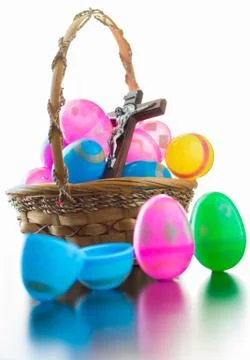 Decorated easter eggs are on a table and in a basket. Stock Photos
