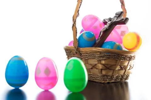 Decorated easter eggs are on a table and in a basket. Stock Photos