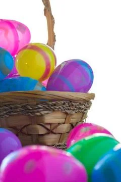 Decorated Easter eggs are on a table and in a basket. Stock Photos