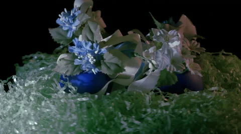 Decorated Easter Eggs in a basket with artificial grass and flowers Stock Footage 36904665