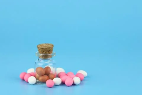 Decorated easter eggs in bottle with blue background Stock Photos