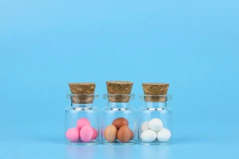 Decorated easter eggs in bottle with blue background Stock Photos