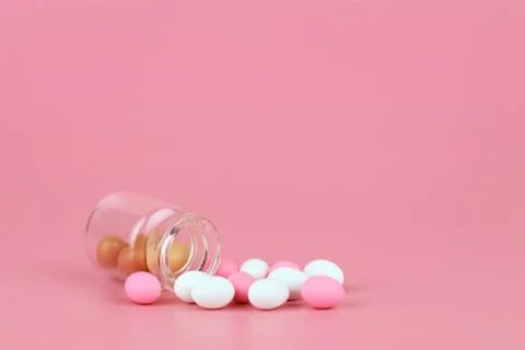 Decorated easter eggs in bottle with pink background Stock Photos