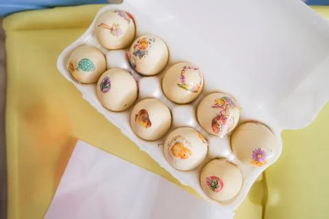 Decorated Easter eggs with decals in a white carton container. Holiday Stock Photos