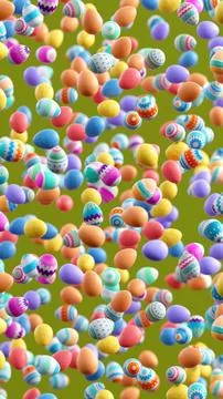 Decorated Easter eggs falling on green background, festive spring holiday c.. Photos