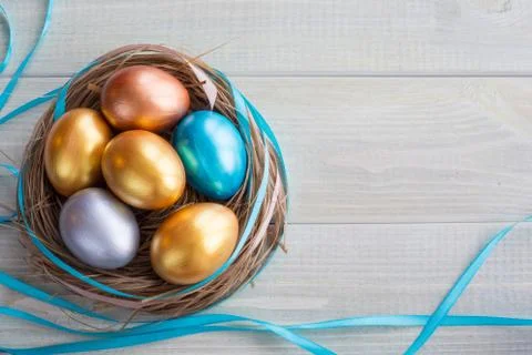 Decorated easter nest with eggs Stock Photos