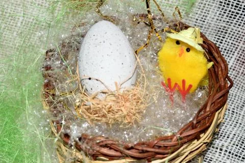 Decorated egg with chick inside a wicker basket Stock Photos
