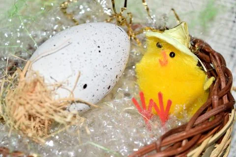 Decorated egg with chick inside a wicker basket Stock Photos