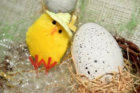 Decorated egg with chick inside a wicker basket 스톡 사진