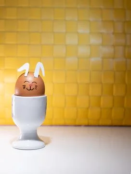 Decorated eggs placed in white egg cups,-1 Stock Photos