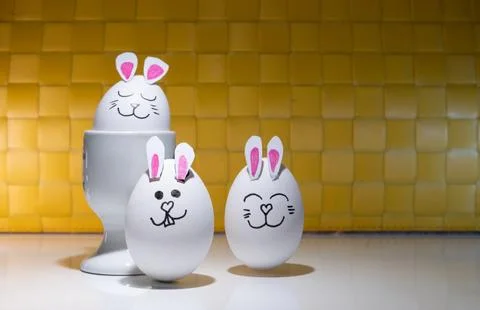 Decorated eggs placed in white egg cups,-2 Stock Photos