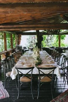 Decorated elegant wedding table for dinner with floral white bouquets Stock Photos