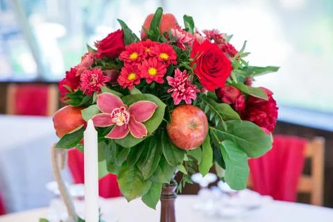 Decorated flowers and apples on the table Stock Photos