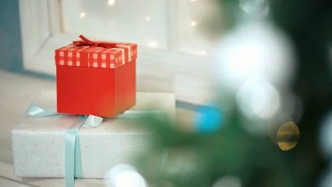 Decorated gift boxes near the Christmas tree Video stock 80990732