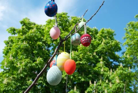 Decorated Handmade Easter Eggs Hanging on Tree Branches in Spring Garden Stock Photos