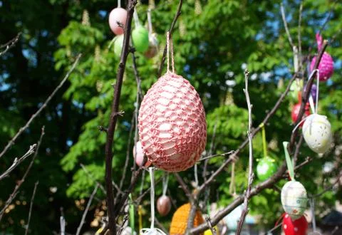 Decorated Handmade Easter Eggs Hanging on Tree Branches in Spring Garden Stock Photos
