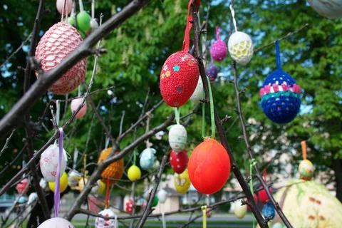 Decorated Handmade Easter Eggs Hanging on Tree Branches in Spring Garden Stock Photos