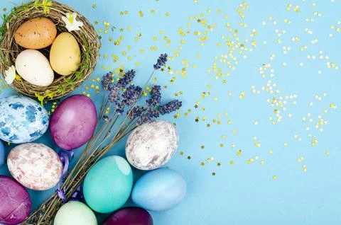 Decorated handmade Easter eggs for the holiday season on blue background. C.. Stock Photos