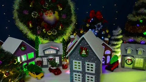 A decorated house rotating in front of a large decorated Christmas village Video stock 319895958
